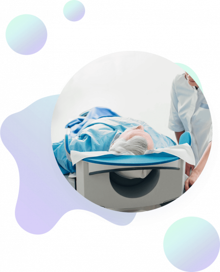 A patient lies on a medical scan table covered with a blue sheet, attended by a healthcare professional. The background features abstract pastel shapes.