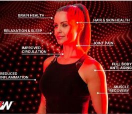 A woman stands under red light with labeled benefits around her, including brain health, hair & skin health, relaxation & sleep, improved circulation, joint pain, reduced inflammation, full body anti-aging, and muscle recovery.